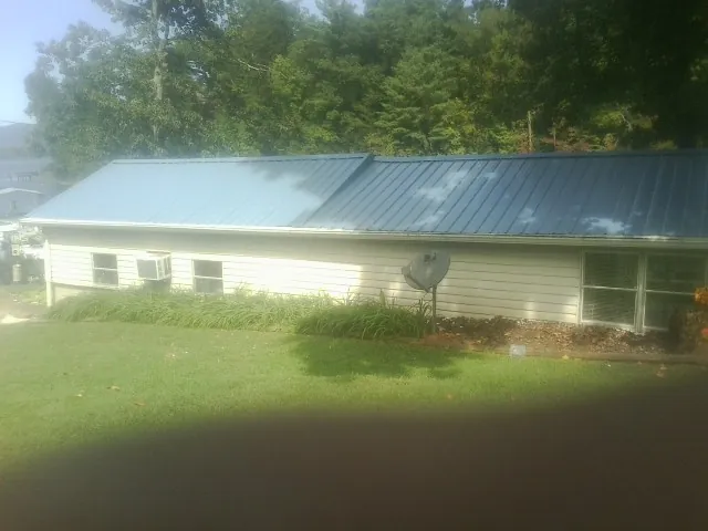 Blue metal roof running the length of a single story home in Anton